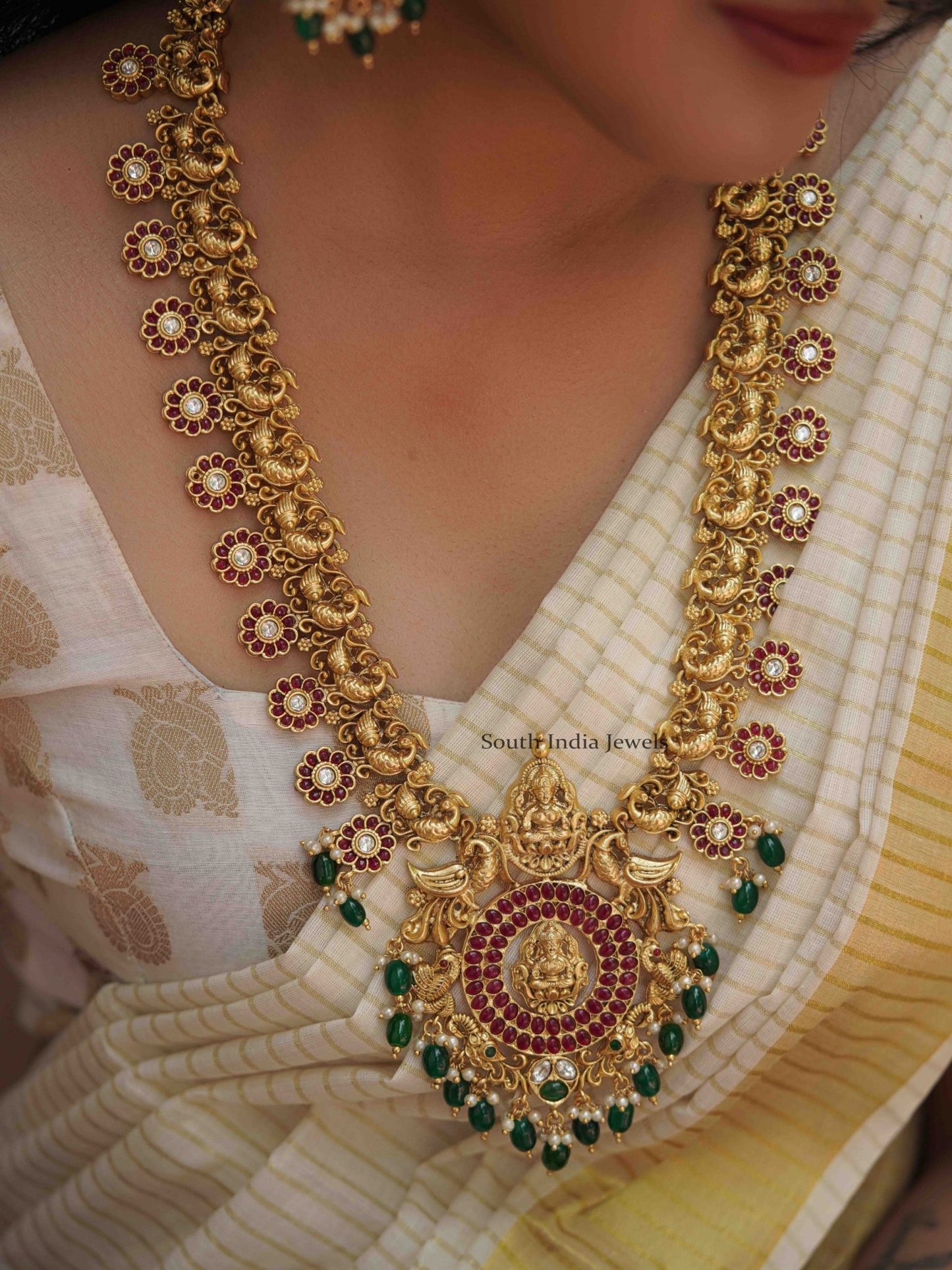 Mangalam peacock design kemp stone haram along with matching Earrings.